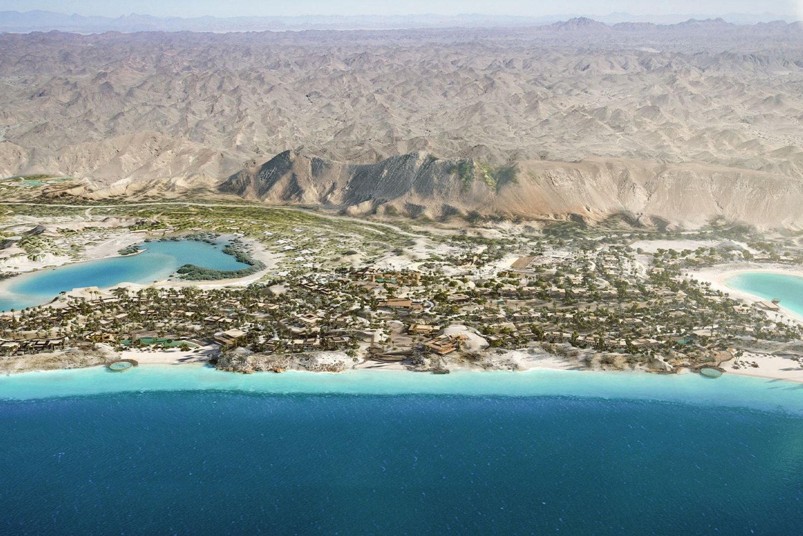 Aerial view of the AMAALA coastal resort with a lagoon, beaches and desert mountains