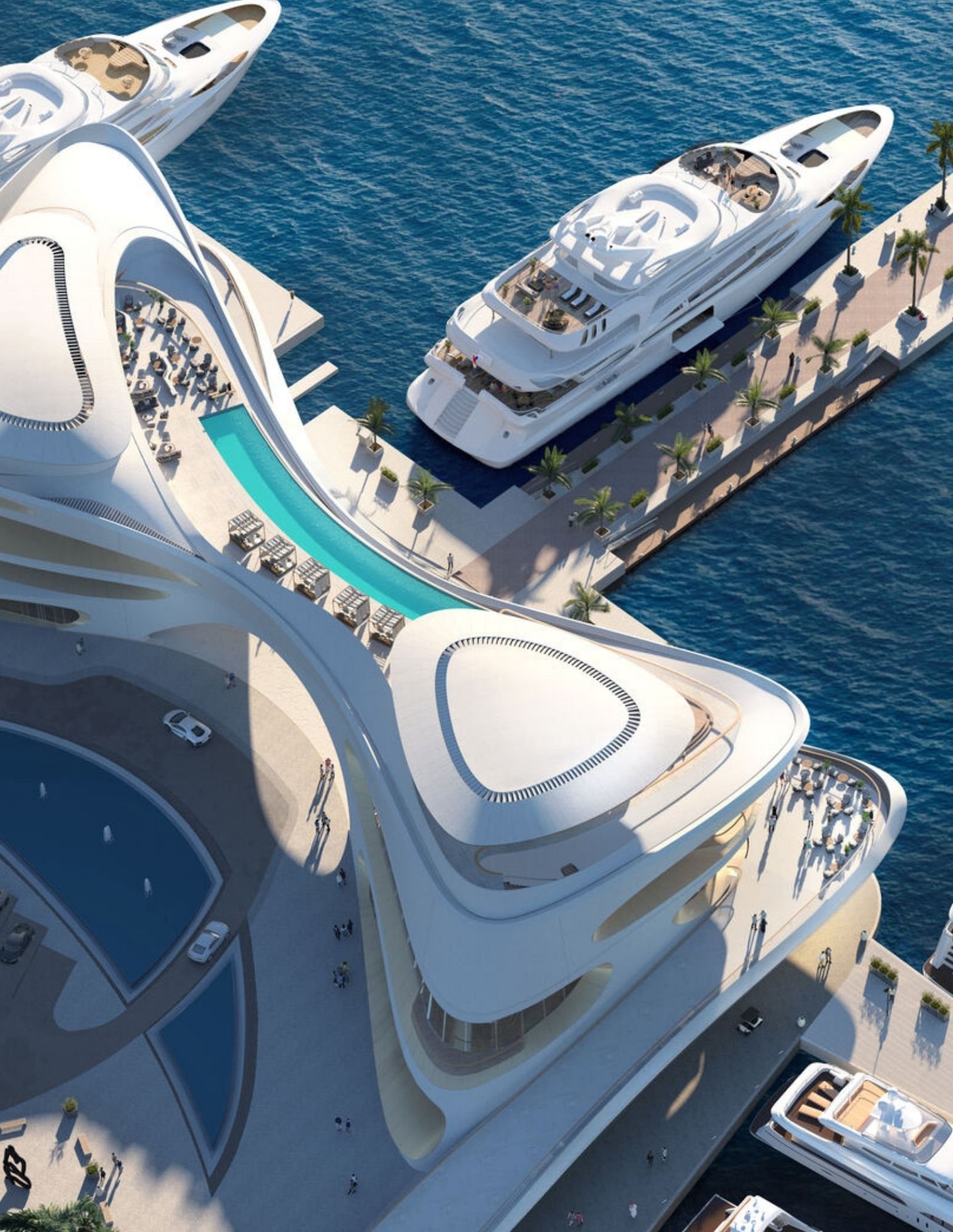 Aerial view of the AMAALA marina with a superyacht moored beside organic resort architecture