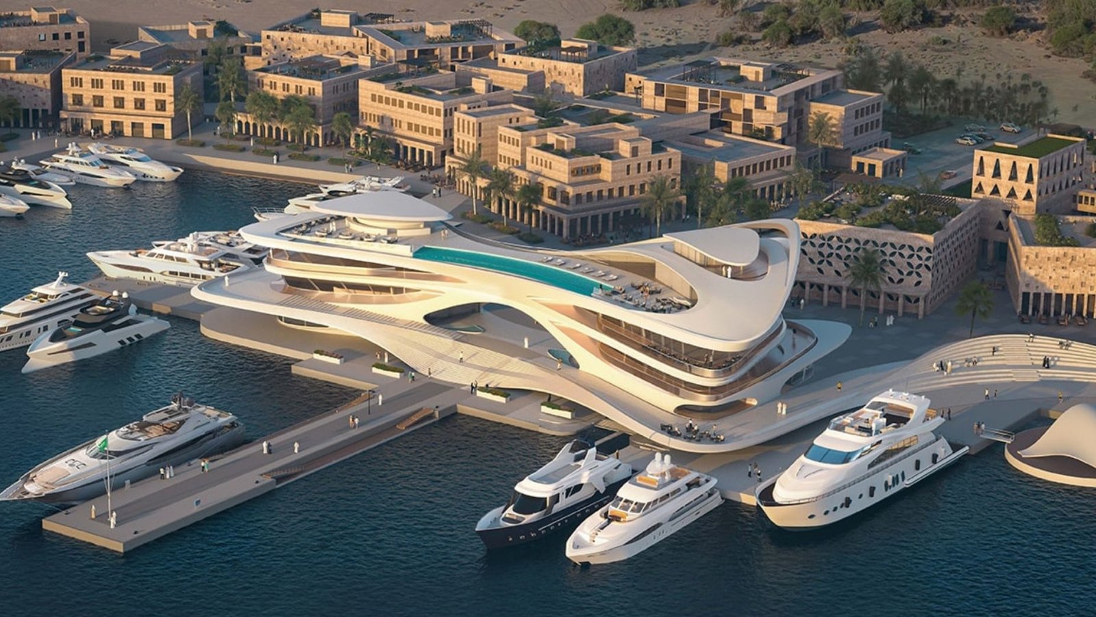 Golden-hour view of the AMAALA yacht club and superyacht marina in front of the coastal town