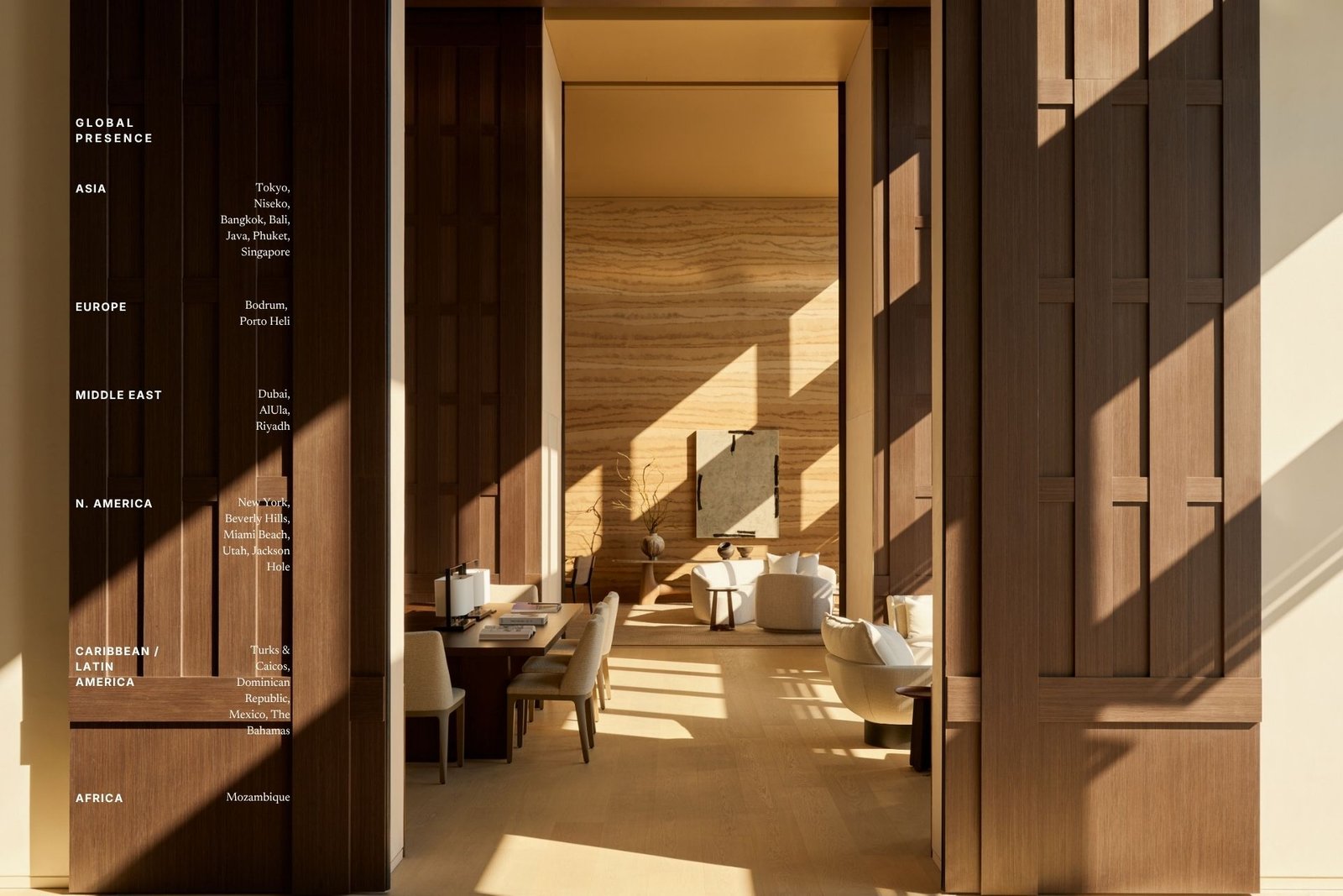 A sunlit Aman residence interior framed by dark wood paneling, with cream sofas and a dining setting, overlaid with a 'Global Presence' list of Aman destinations across six regions.