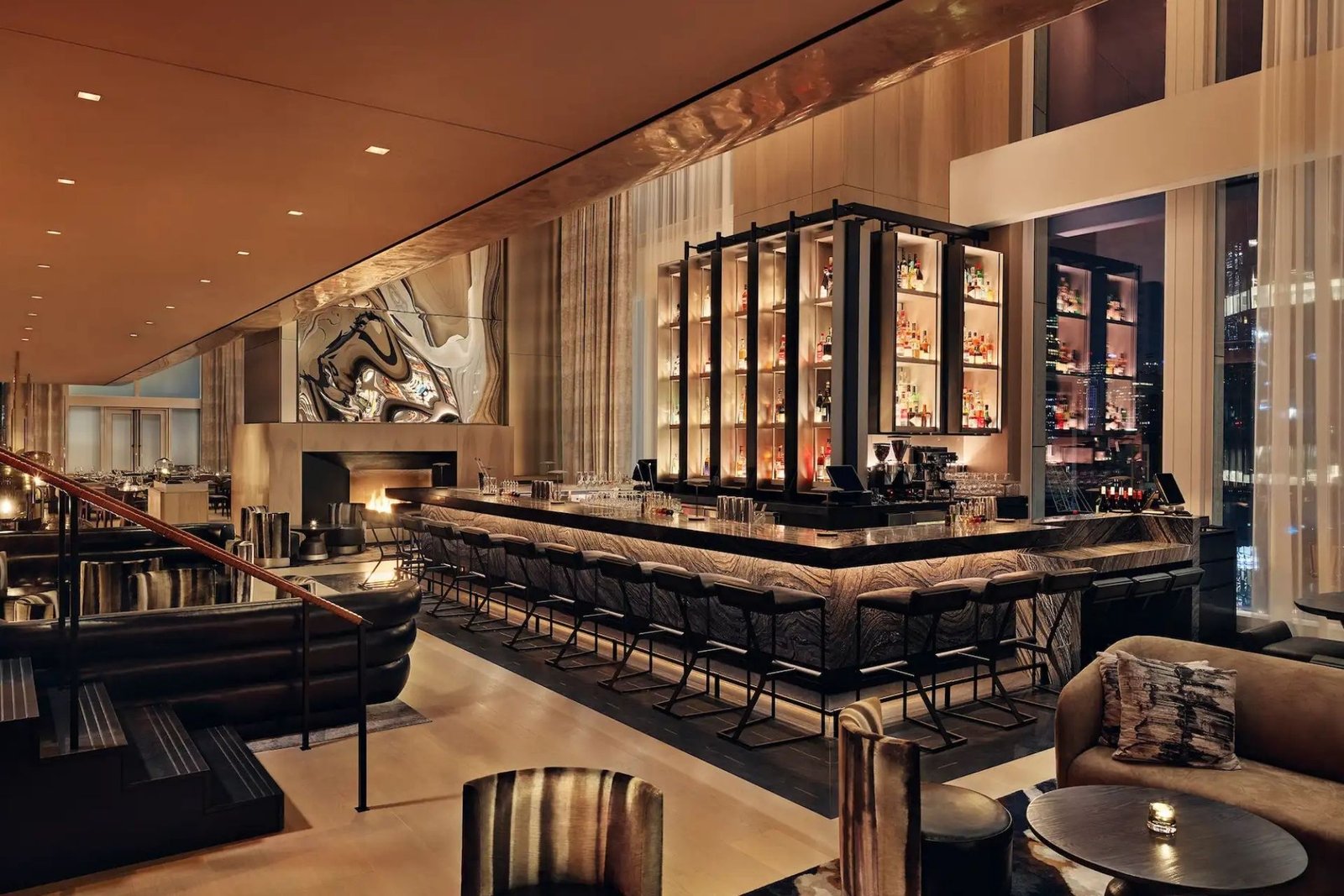 Backlit stone bar and lounge at the Equinox Hotel at night