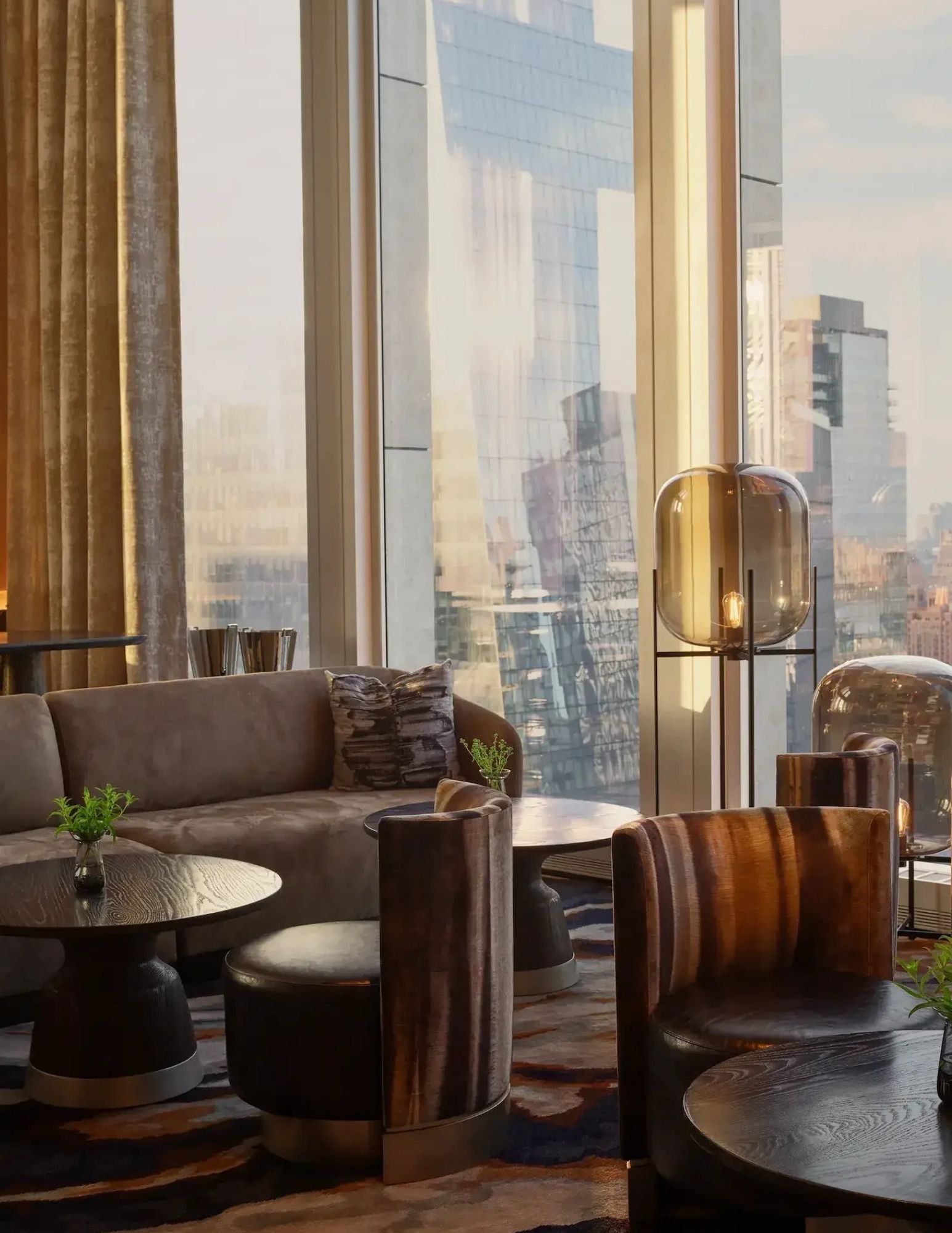 Residents lounge with velvet seating above the Manhattan skyline
