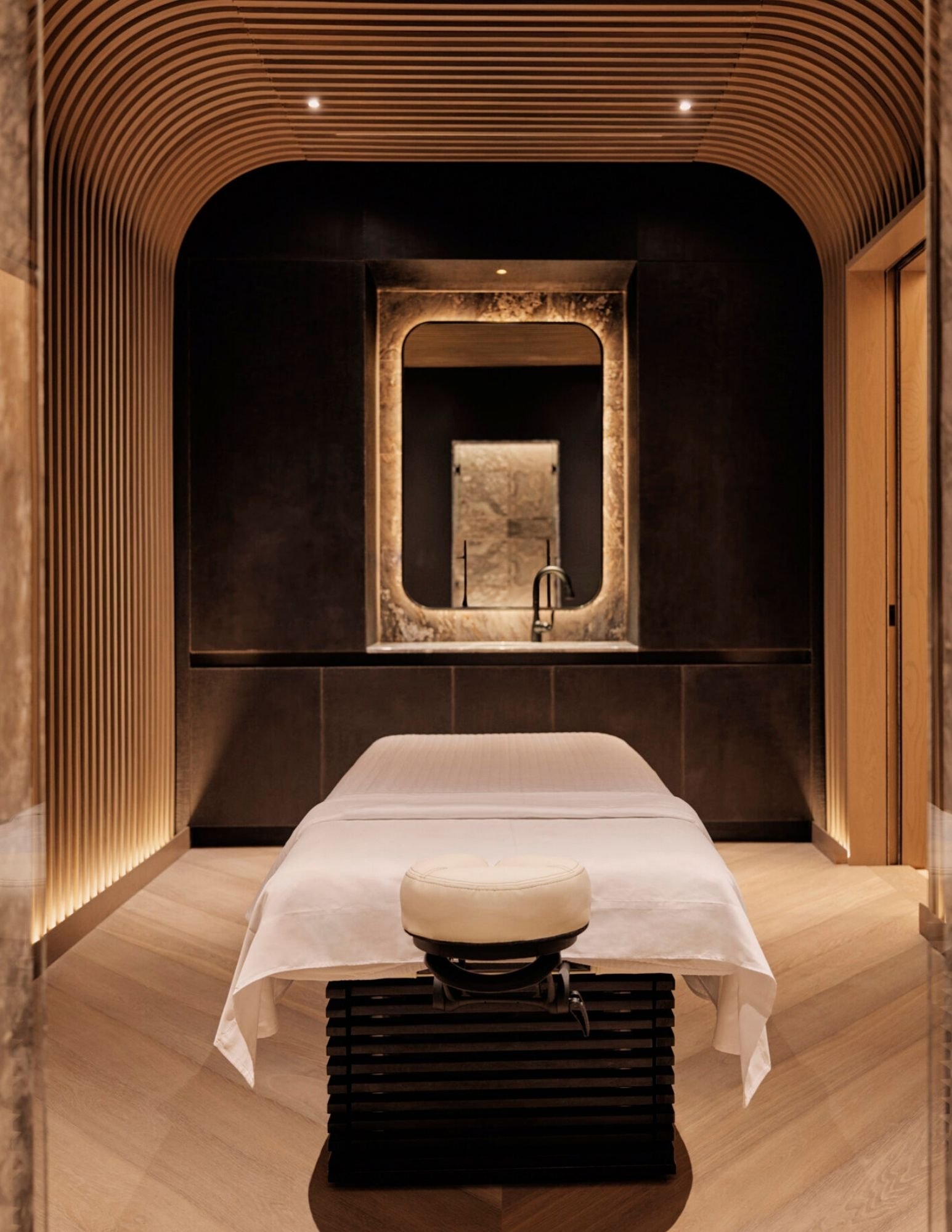 Vaulted spa treatment room at the Equinox Hotel with a massage table