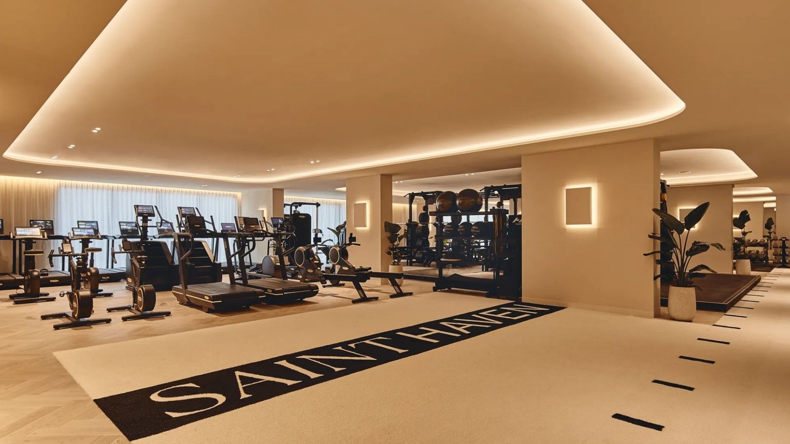 Saint Haven gym floor with a branded runner across cream flooring